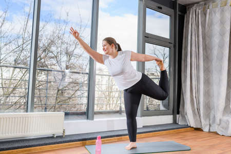 Body positive woman stretch legs and handsの写真素材