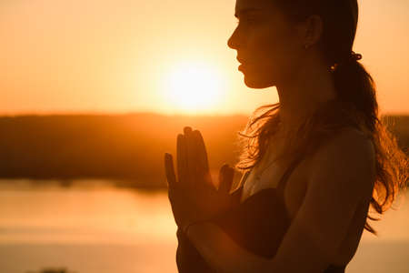 Sunny portrait of woman in warm backlitの写真素材