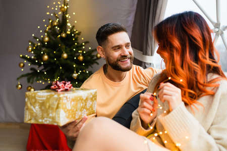 Young couple are sitting in a cozy geo dome tentsの写真素材