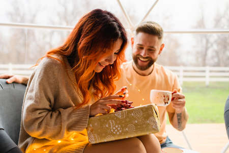 Young couple are sitting in a cozy geo dome tentsの写真素材