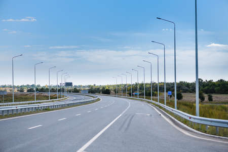 View of an empty highway with road lines and road signsの写真素材
