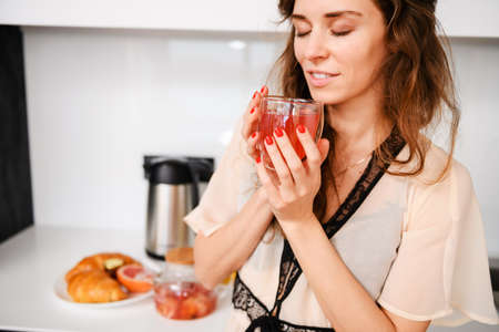 Woman enjoy breakfast morning cup of teaの写真素材