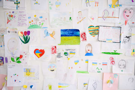 Dnipro, Ukraine - April 04, 2022: Many children's drawings about the war in Ukraine. A wall of children's messages about peace in Ukraine.のeditorial素材