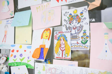 Dnipro, Ukraine - April 04, 2022: Many children's drawings about the war in Ukraine. A wall of children's messages about peace in Ukraine. Refugee Assistance Center in Dnipro.のeditorial素材