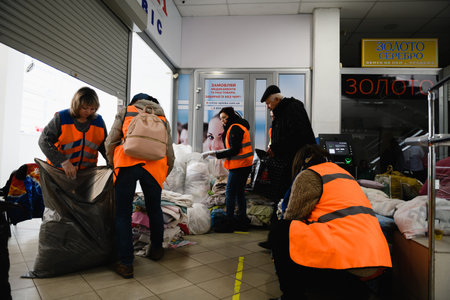 Dnipro, Ukraine - April 04, 2022: Volunteers sort clothes for refugees in the mall in Dnipro.のeditorial素材
