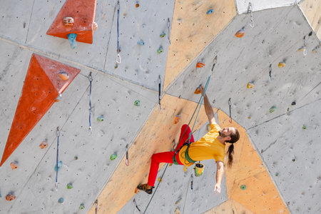 Young and fit man exercise free mountain climbing on outdoor practice wall. top view.の写真素材