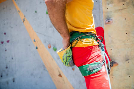 Rock climber man shoved his hands into a bag of magnesia powder behind his back. close-up.の写真素材