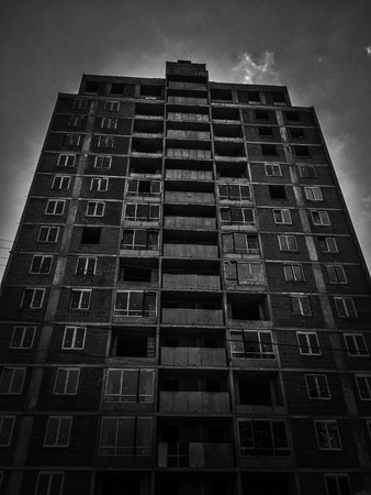 Look up to the tall building. Black and white photo. Modern background