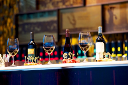 snacks and glasses of wine on restaurant counter
