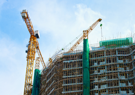 two cranes on construction of a large high-rise building in city