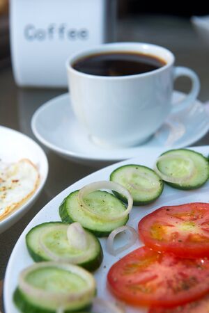 Coffee cup, egg and salad breakfast on tableの写真素材