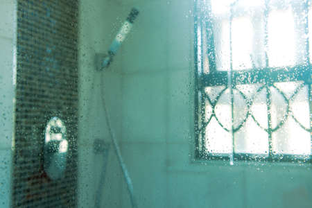 Drops of water on glass of shower cabin background