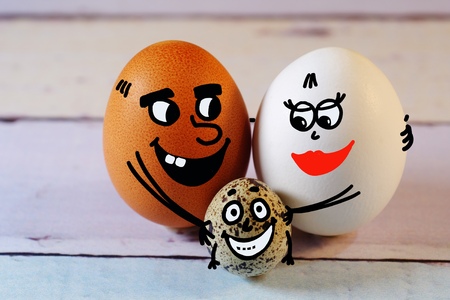 A family of different color eggs and a misc baby egg.の写真素材