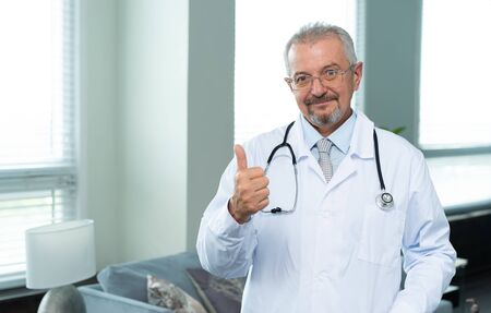 Caucasian adult happy doctor smiling and pointingの写真素材