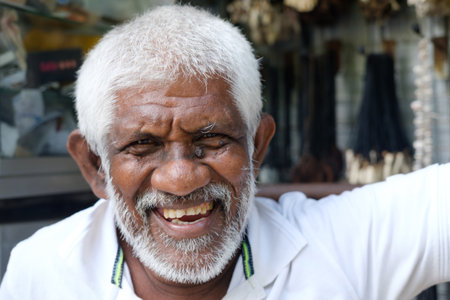 A Joyful Elderly Man Smiling Happily While Enjoying the Outdoors on a Beautiful Dayの写真素材