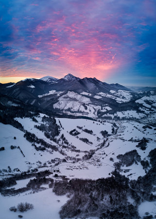Amazing winter dawn scenery with snowy mountains. Picturesque sunrise and snowy mountain ridge in background, Carpathians, Slovakia, Europeの写真素材