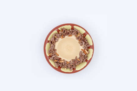 Hummus with meat and pine seedsの写真素材