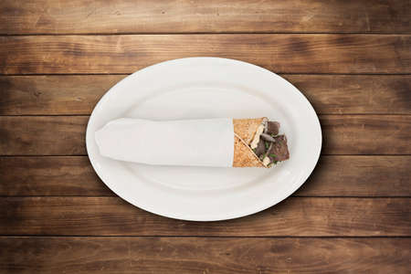 Meat shawarma sandwich on a white plateの写真素材