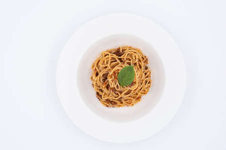 Traditional bolognese pasta with a basil leaf on topの写真素材