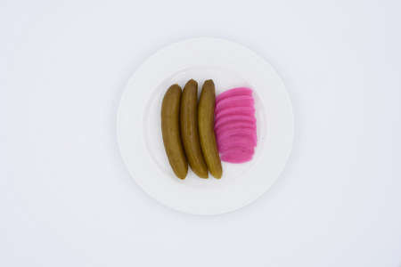 Cucumber pickles in a white plateの写真素材