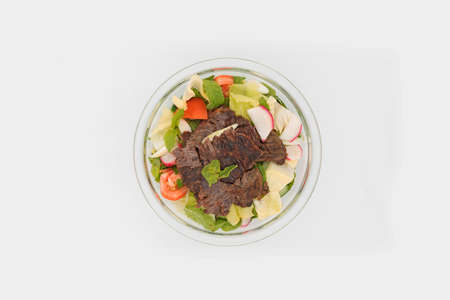 Seasonal salad with meat slices on topの写真素材