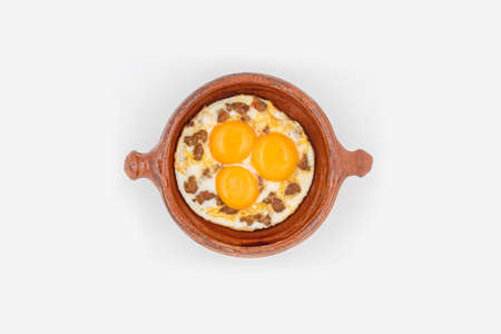 Fried eggs with meat in a pottery bowlの写真素材