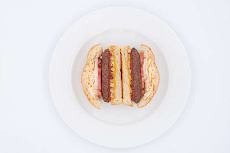 Burger on a white plate cut in halfの写真素材