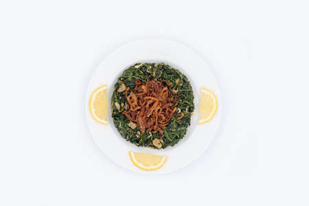 Hindbe chicory with fried onions and lemonの写真素材