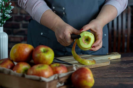 Women preparing delicious apple tart or pie large  on wood table background.