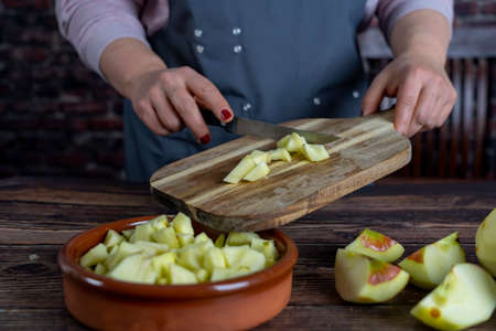 Women preparing delicious apple tart or pie large  on wood table background.の写真素材