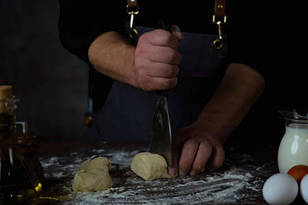 Row bread dough divided by man or pastry chef or baker.の写真素材