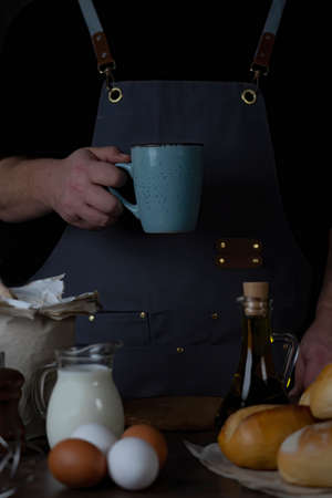 Working baker Man  holding with his hand a  cup,in his Break.の写真素材