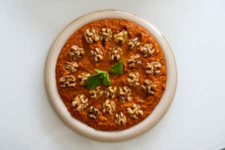 Red Muhammara close-up on table. horizontal top view , hot pepper dip originally from Syria, Lebanon.の写真素材