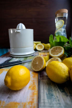 Preparation of fresh juices press on fresh lemon and lime. lemon squeezer machine or lemon presser.の写真素材