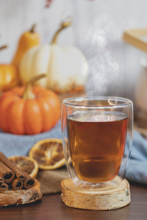 Tea with autumn decor,  pumpkins,dry  Orange slices and cinnamon on table and white  background. Concept of Thanksgiving , Autumn, tea,herbal tea .の写真素材