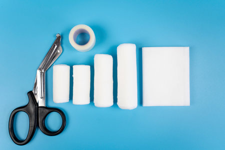 First aid kit against blue colored surface.