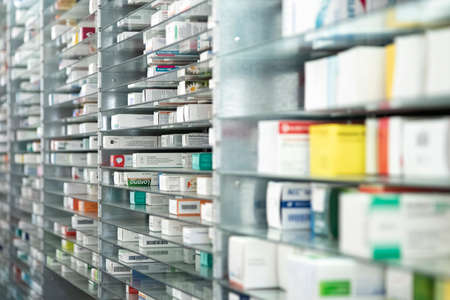 A pharmacy storage room ,Drugs are arranging and stored on a glass shelf in a pharmacy.taken out with a robot handのeditorial素材