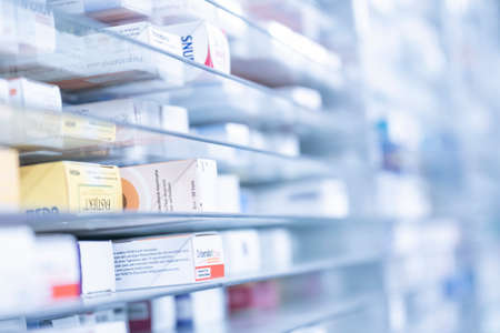 A pharmacy storage room ,Drugs are arranging and stored on a glass shelf in a pharmacy.taken out with a robot handのeditorial素材