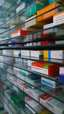 A pharmacy storage room ,Drugs are arranging and stored on a glass shelf in a pharmacy.taken out with a robot handのeditorial素材