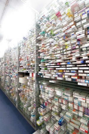 A pharmacy storage room ,Drugs are arranging and stored on a glass shelf in a pharmacy.taken out with a robot handのeditorial素材