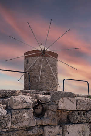 Windmills in Mandraki Harbor at sunset time.の写真素材