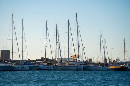 Boat masts in row in a sunny day.in Black and white.
