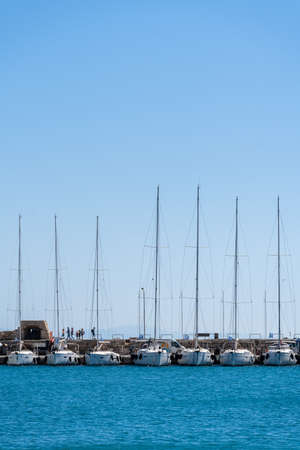 Boat masts in row in a sunny day.in Black and white.