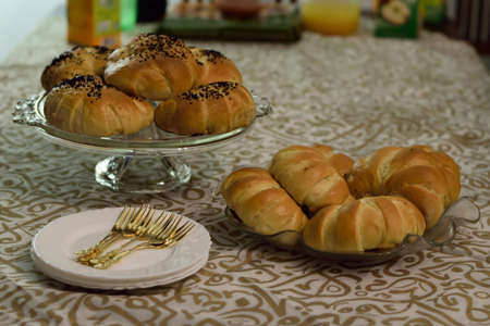 Homemade Croissant, served on a table with tablecloth - Arabic letters