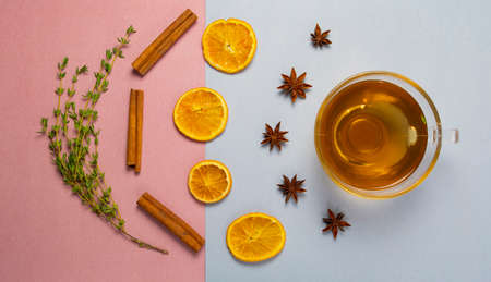 Herbal tea on pascal color background rose and blue - thymian cinnamon lemon orange anise  top view or flatの写真素材
