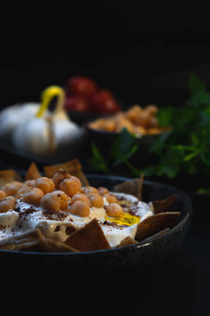 Levantine fatteh, fattet hummus typically consists of toasted or fried pieces of pita bread and...