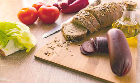 Breakfast ,Sausage and bread.on a Wooden table.Side view morning light.の写真素材