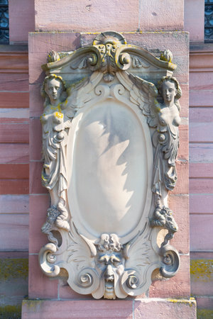 Stone frame on wall with women on the sideの写真素材