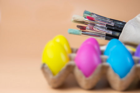 Paint brushes and colorful Easter eggs close upの写真素材