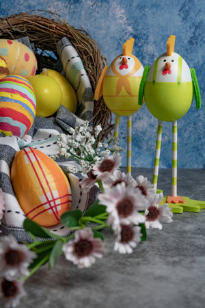 Colorful Easter eggs in row and eggs in form of chicks standing beside